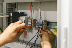 Electrician with a screwdriver macro connect wires