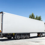 White truck equipped with refrigeration goods parked at a gas station in Spain